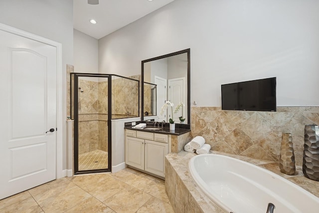 bathroom featuring vanity, a shower stall, and a bath