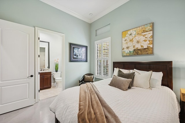 bedroom featuring light wood-type flooring, connected bathroom, and ornamental molding