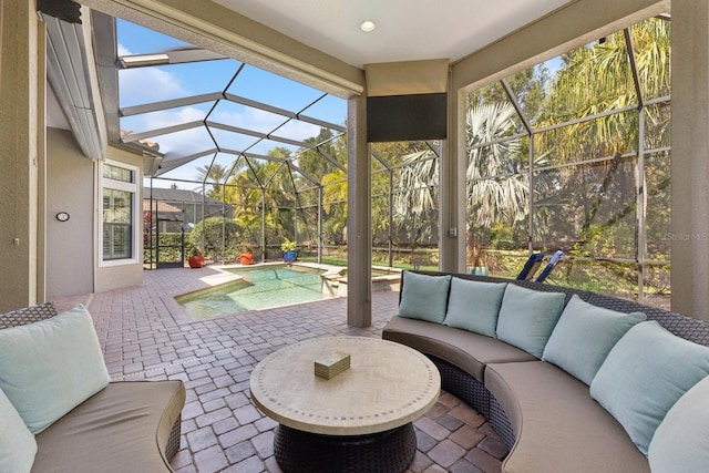 view of patio / terrace with a lanai, outdoor lounge area, and a pool with connected hot tub