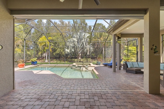 view of pool with outdoor lounge area, a patio, a pool with connected hot tub, and a lanai