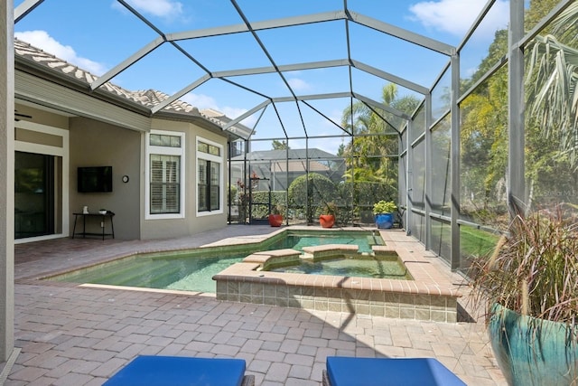 view of swimming pool with glass enclosure, a patio area, and a pool with connected hot tub