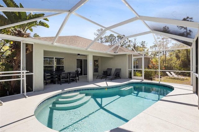 pool featuring a patio area, a lanai, and a ceiling fan