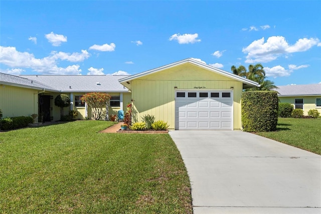 ranch-style house with driveway, a front yard, and a garage