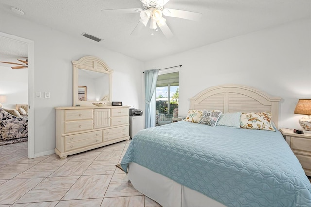 bedroom featuring visible vents, a ceiling fan, a textured ceiling, baseboards, and access to exterior