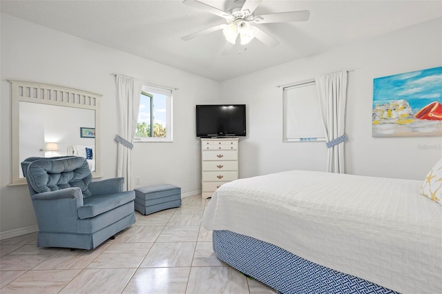 bedroom featuring a ceiling fan, baseboards, and marble finish floor