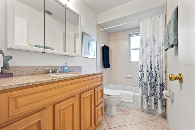 bathroom with vanity, visible vents, tile patterned flooring, shower / bath combo with shower curtain, and toilet