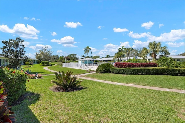 view of home's community featuring a lawn