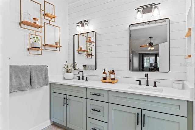 bathroom with double vanity, a ceiling fan, and a sink