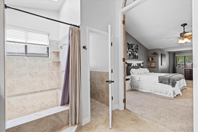 bedroom with ceiling fan, light carpet, light tile patterned flooring, and vaulted ceiling