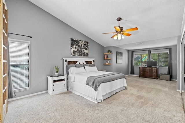 carpeted bedroom featuring high vaulted ceiling, a ceiling fan, baseboards, and a textured ceiling