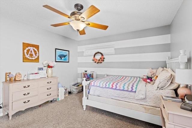 bedroom featuring light colored carpet, a ceiling fan, and a textured ceiling