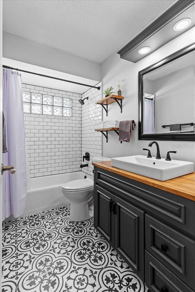 bathroom with vanity, shower / tub combo, a textured ceiling, tile patterned floors, and toilet