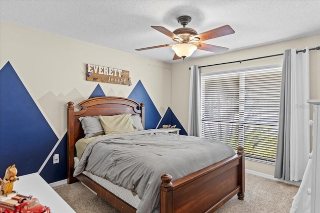 carpeted bedroom with ceiling fan, a textured ceiling, and baseboards