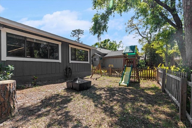 view of yard featuring a playground and a fenced backyard