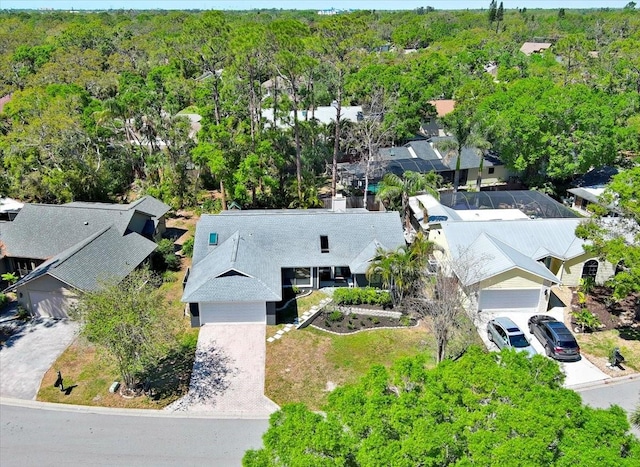 birds eye view of property with a view of trees and a residential view