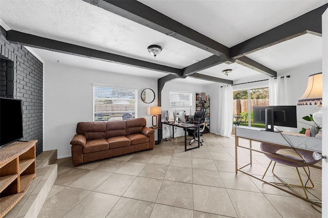 living room with beam ceiling, light tile patterned floors, and a textured ceiling