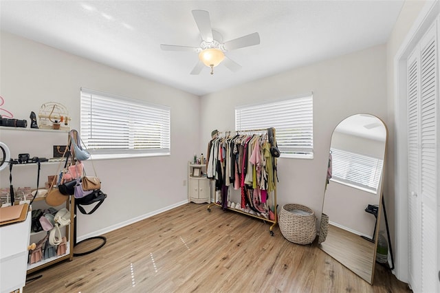 misc room with ceiling fan, baseboards, and wood finished floors