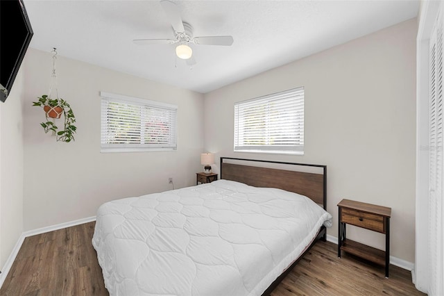 bedroom featuring ceiling fan, baseboards, and wood finished floors