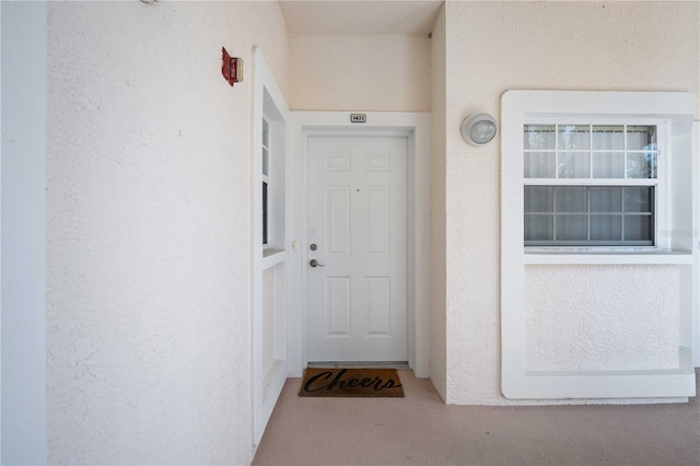 view of exterior entry with stucco siding