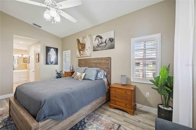 bedroom featuring visible vents, baseboards, lofted ceiling, and wood finished floors