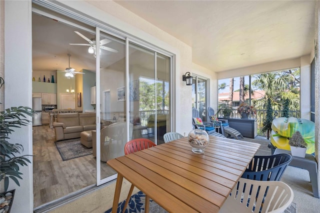 sunroom with lofted ceiling and a ceiling fan