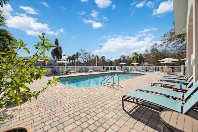 pool featuring a patio and fence