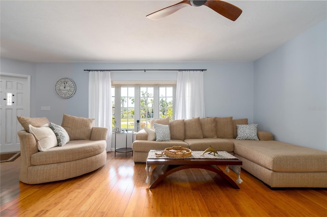 living room with light wood-type flooring and ceiling fan