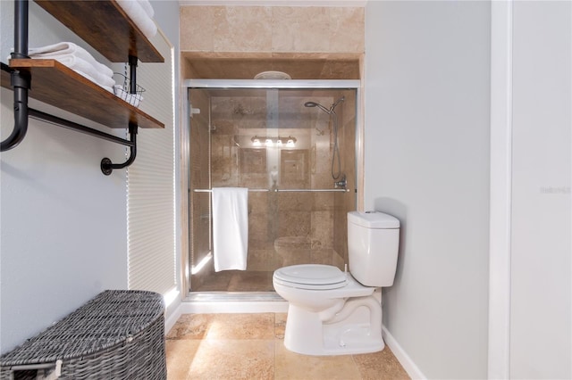 full bath featuring a shower stall, toilet, and baseboards