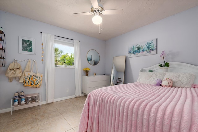 tiled bedroom featuring a ceiling fan and baseboards