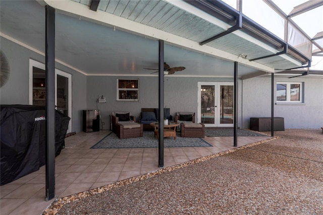 view of patio with a ceiling fan, a lanai, and french doors