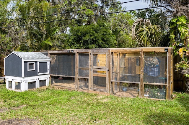 view of poultry coop featuring a lawn