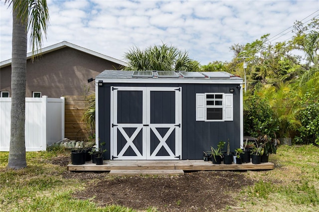 view of shed featuring fence