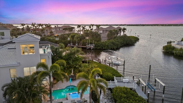 birds eye view of property featuring a water view and a residential view