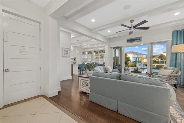 living room with wood finished floors, baseboards, beam ceiling, recessed lighting, and ceiling fan