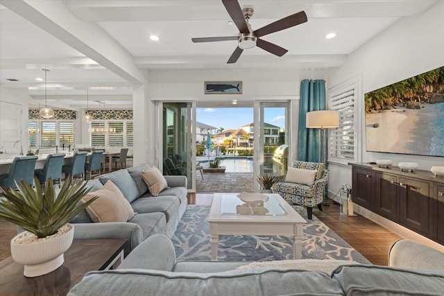 living area with recessed lighting, beamed ceiling, wood finished floors, and a ceiling fan