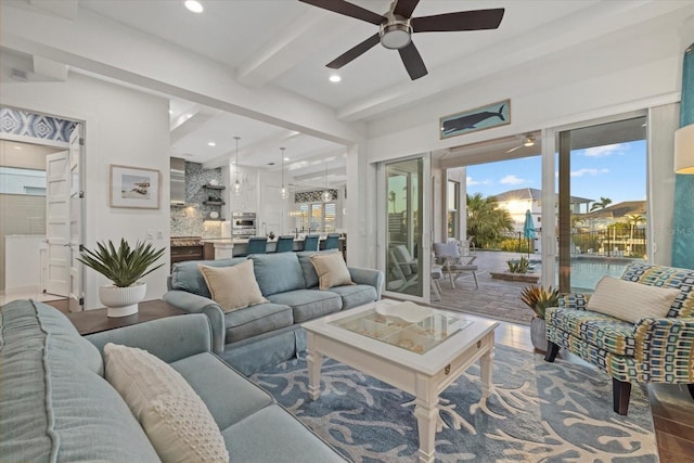 living area featuring a ceiling fan, beam ceiling, plenty of natural light, and recessed lighting