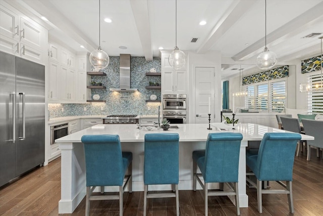 kitchen featuring open shelves, beam ceiling, appliances with stainless steel finishes, wall chimney exhaust hood, and dark wood-style flooring