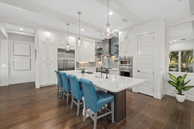 kitchen with dark wood finished floors, open shelves, appliances with stainless steel finishes, white cabinetry, and backsplash