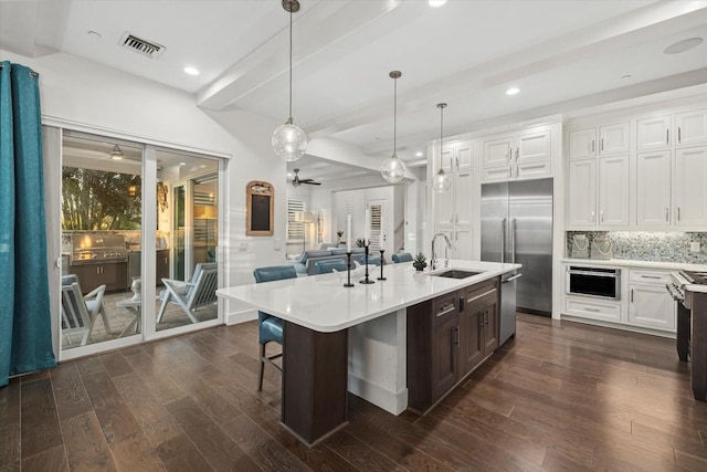 kitchen with a sink, visible vents, appliances with stainless steel finishes, and light countertops