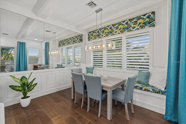 dining room with visible vents, beamed ceiling, and dark wood-style flooring