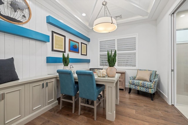 dining space featuring dark wood finished floors, crown molding, baseboards, and visible vents