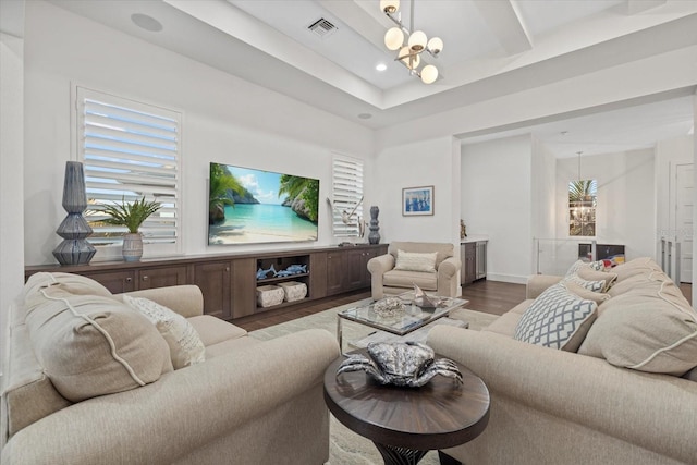 living area with recessed lighting, wood finished floors, visible vents, and a chandelier