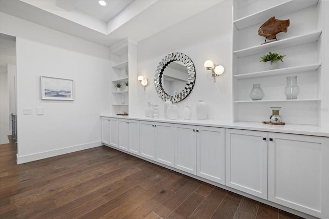 bar with built in features, recessed lighting, dark wood-type flooring, and baseboards