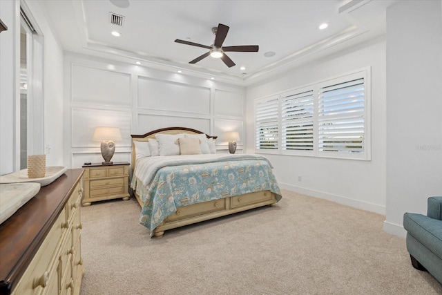 bedroom featuring visible vents, baseboards, light carpet, recessed lighting, and a decorative wall