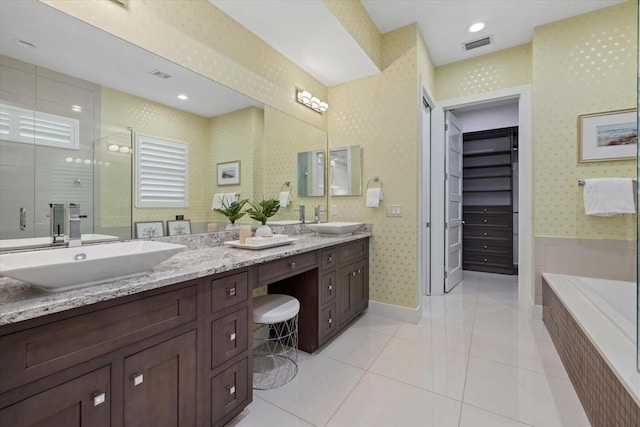 full bathroom with visible vents, a shower stall, wallpapered walls, and a sink