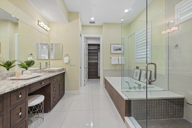 bathroom featuring visible vents, a shower stall, double vanity, tile patterned floors, and a sink