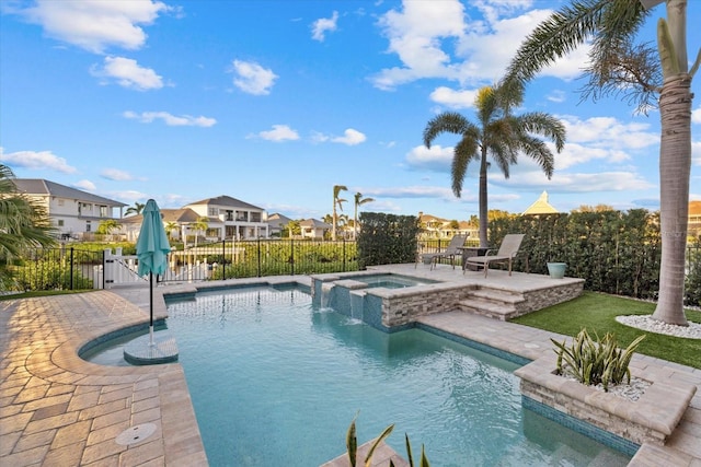 view of pool with fence, a residential view, a fenced in pool, an in ground hot tub, and a patio area