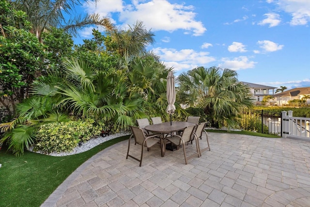 view of patio / terrace featuring a gate, outdoor dining area, and fence