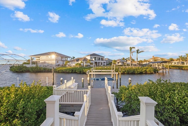 view of dock with boat lift and a water view