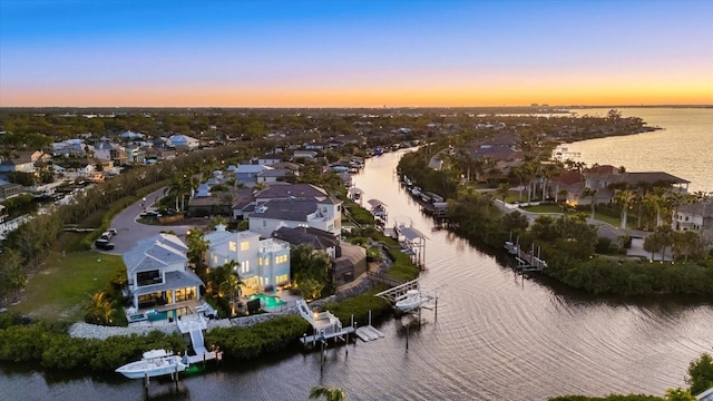 drone / aerial view featuring a residential view and a water view